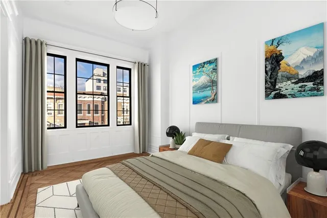 a bedroom with a bed and a painting on the wall