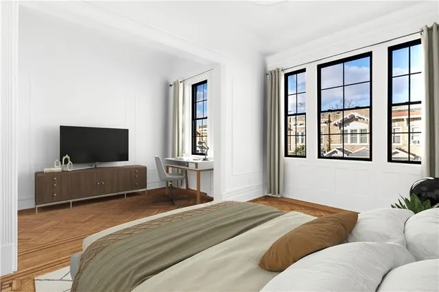 a bedroom with a bed and a television