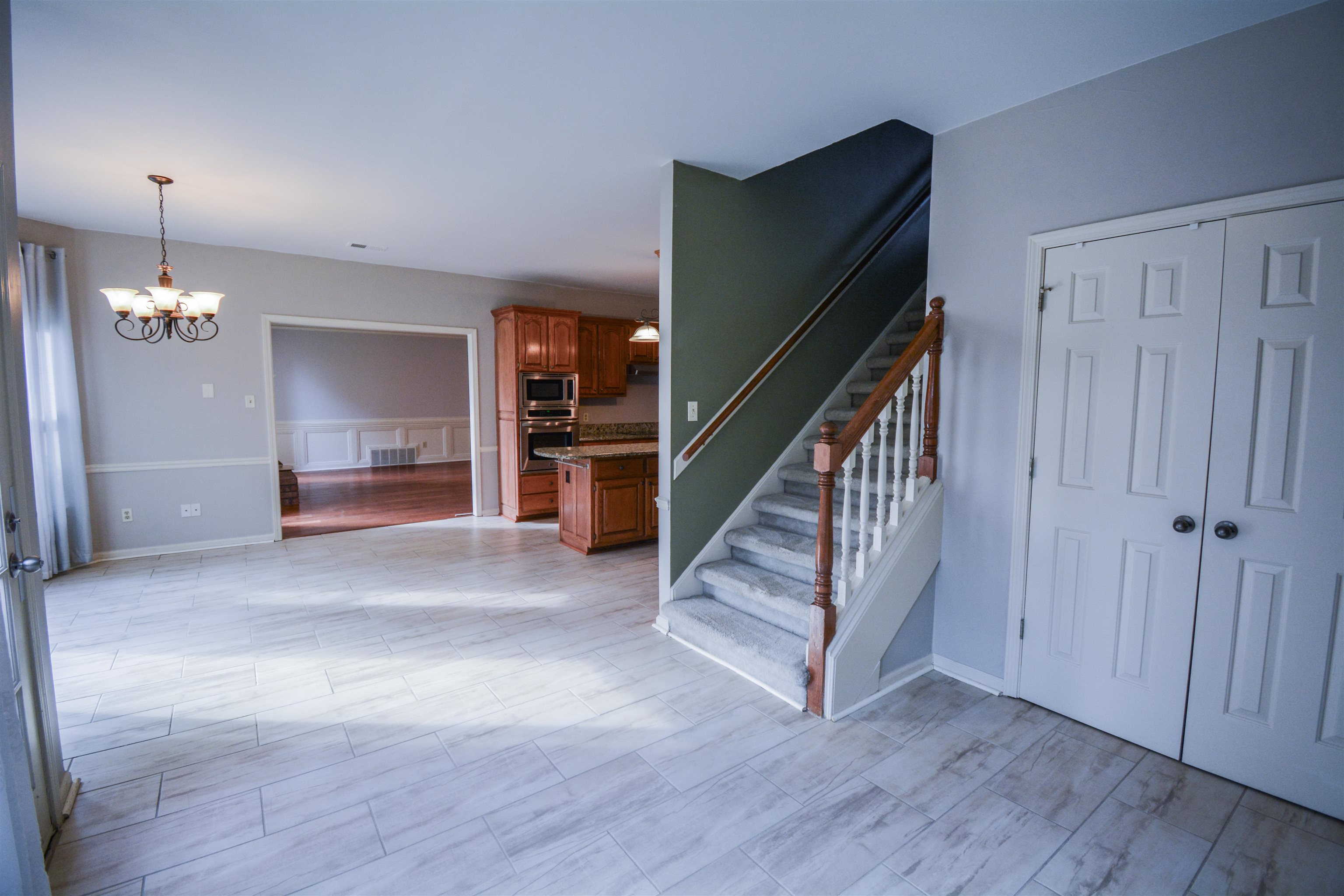 745 Roehampton Court Collierville, TN 38017 - Photo 13 of 40 a view of a livingroom with wooden floor and stairs