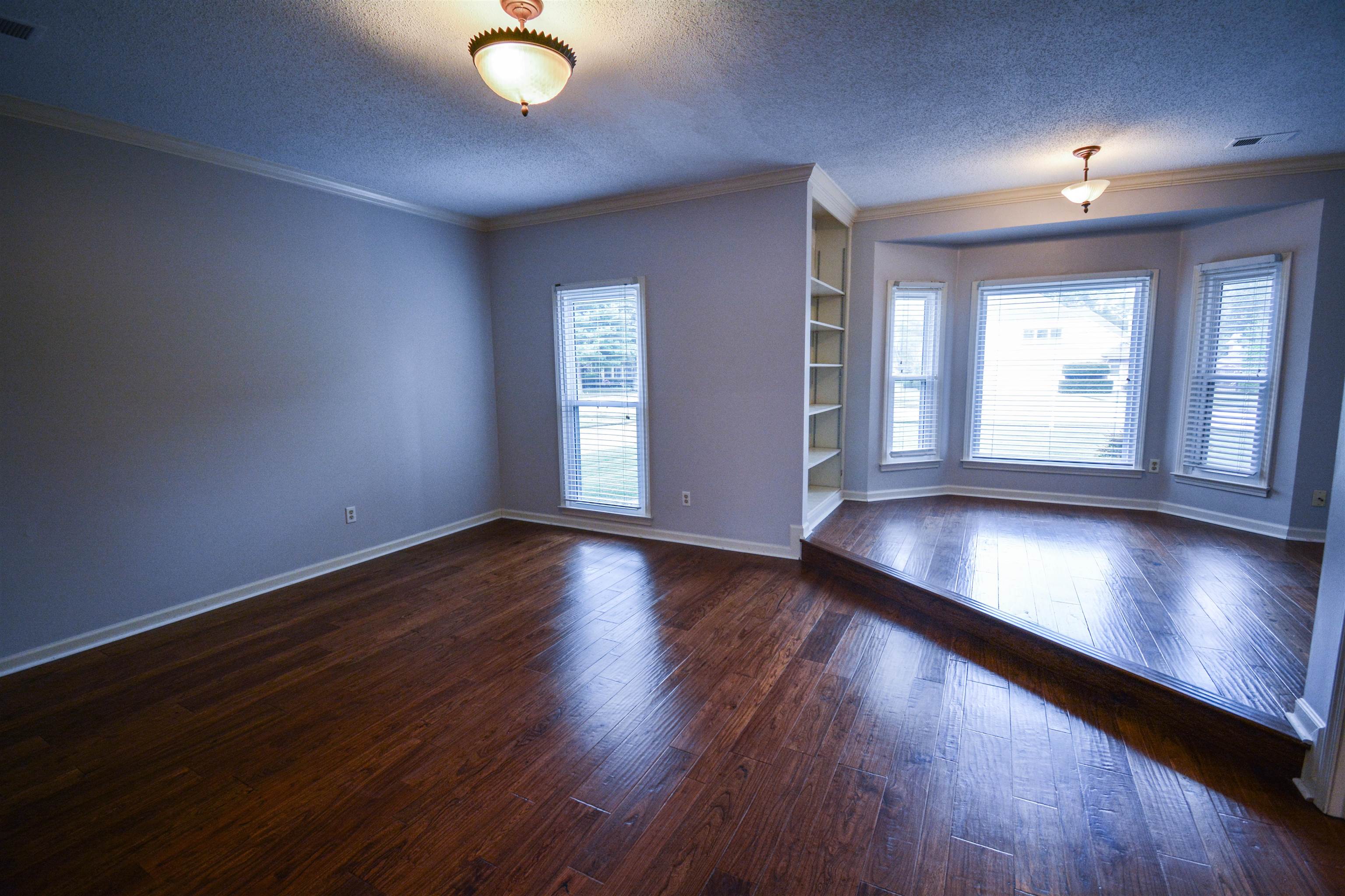 745 Roehampton Court Collierville, TN 38017 - Photo 15 of 40 an empty room with wooden floor and windows