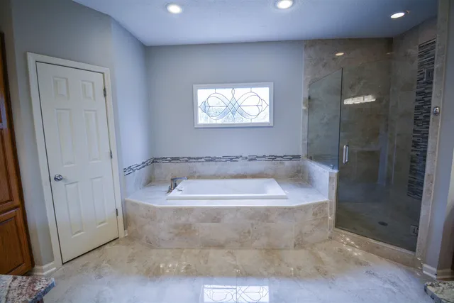 a kitchen with stainless steel appliances granite countertop a kitchen island a stove and a sink