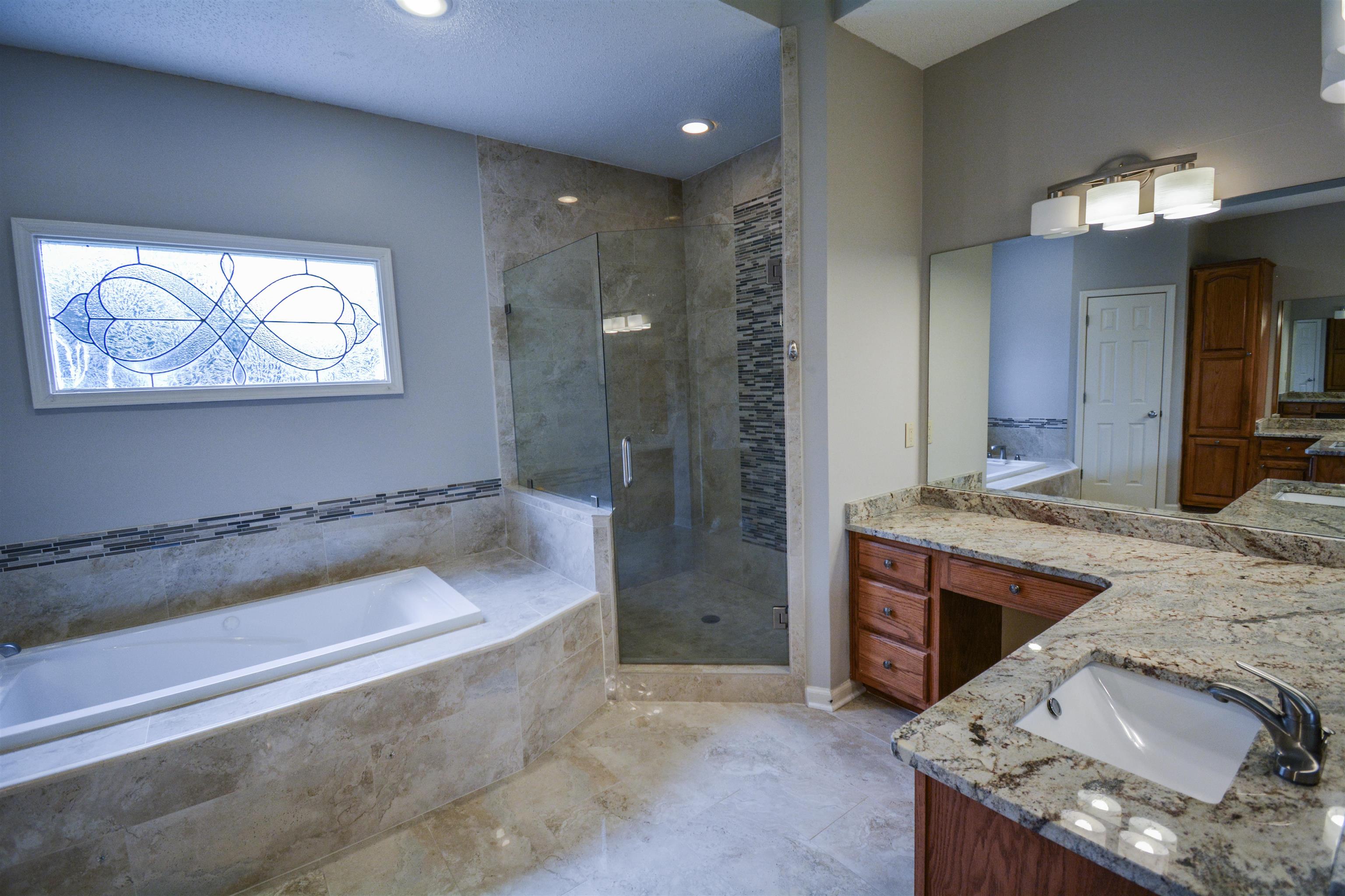 745 Roehampton Court Collierville, TN 38017 - Photo 19 of 40 a bathroom with a granite countertop sink and mirror