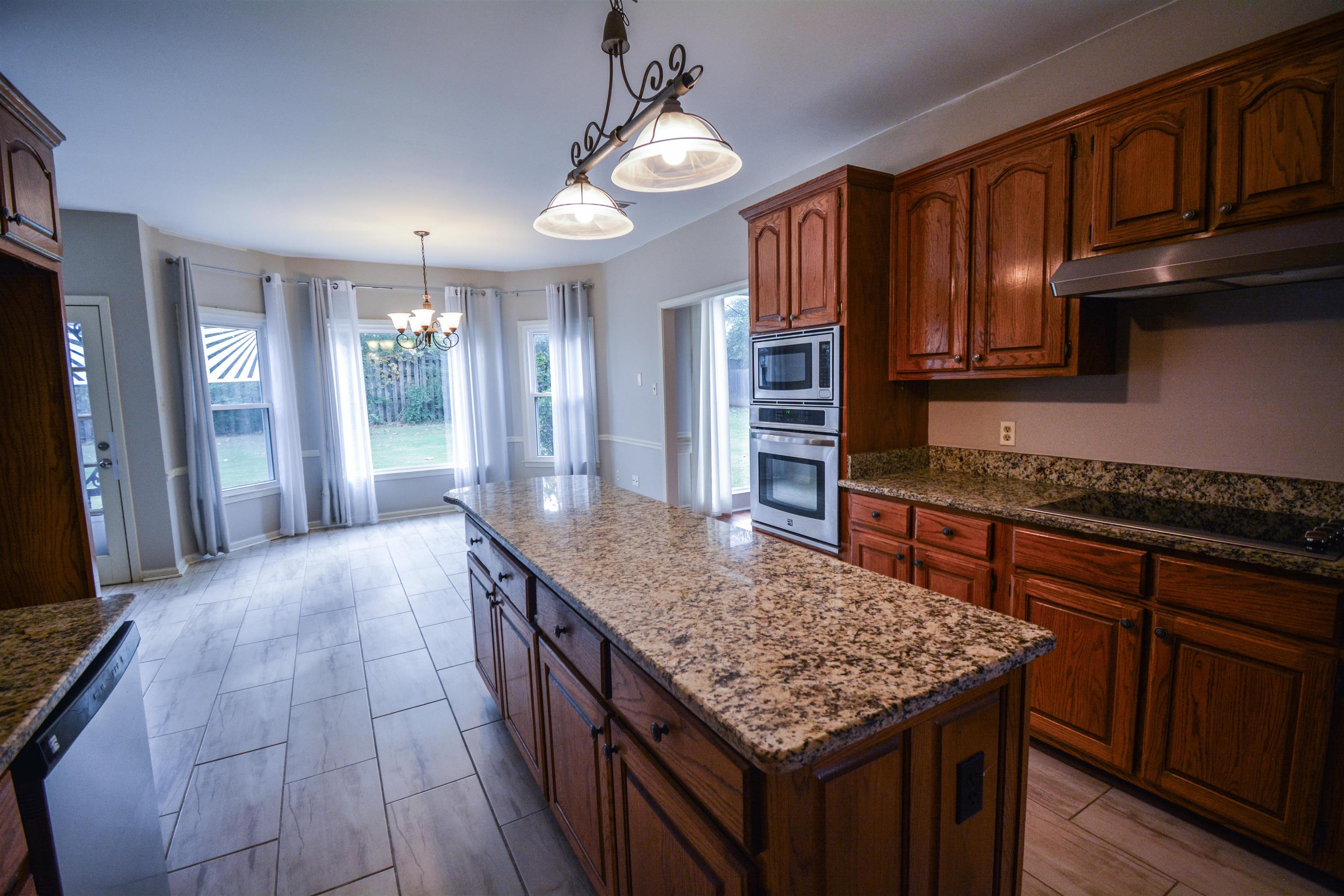 745 Roehampton Court Collierville, TN 38017 - Photo 23 of 40 a kitchen with stainless steel appliances granite countertop a kitchen island a stove and a sink
