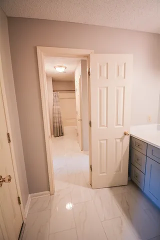a view of a house with a big yard and large trees
