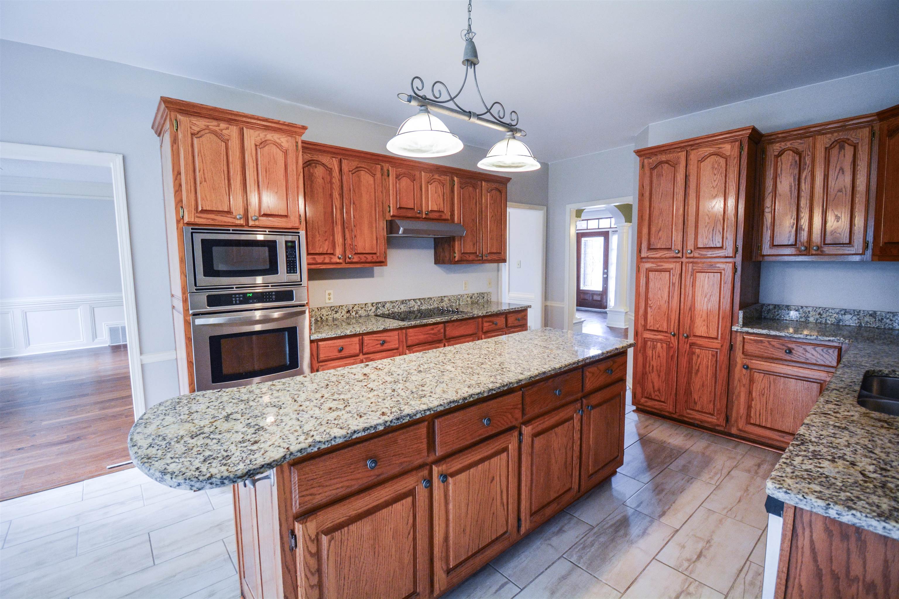 745 Roehampton Court Collierville, TN 38017 - Photo 3 of 40 a kitchen with stainless steel appliances granite countertop wooden cabinets a refrigerator and a stove top oven