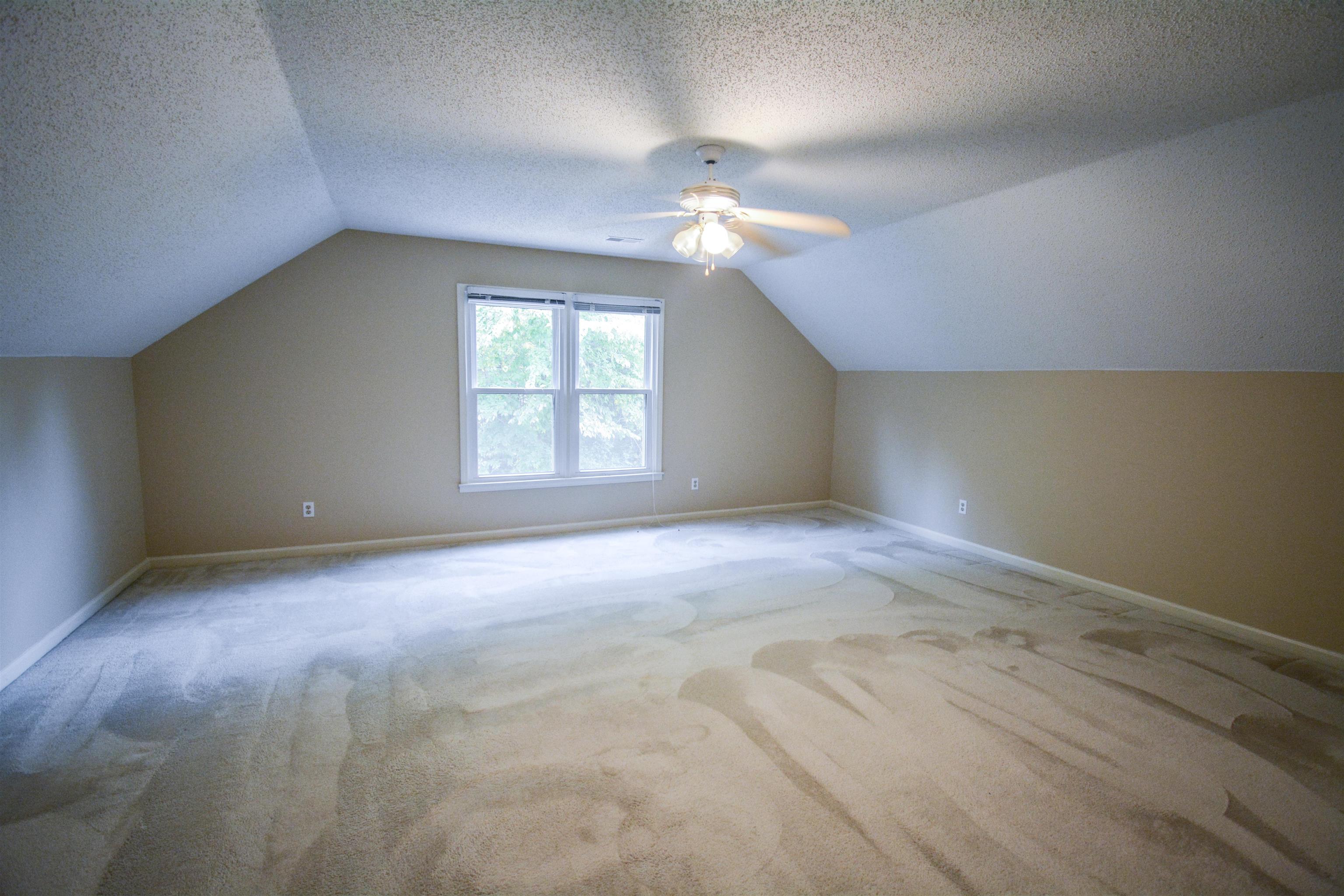 745 Roehampton Court Collierville, TN 38017 - Photo 33 of 40 an empty room with windows and ceiling fan