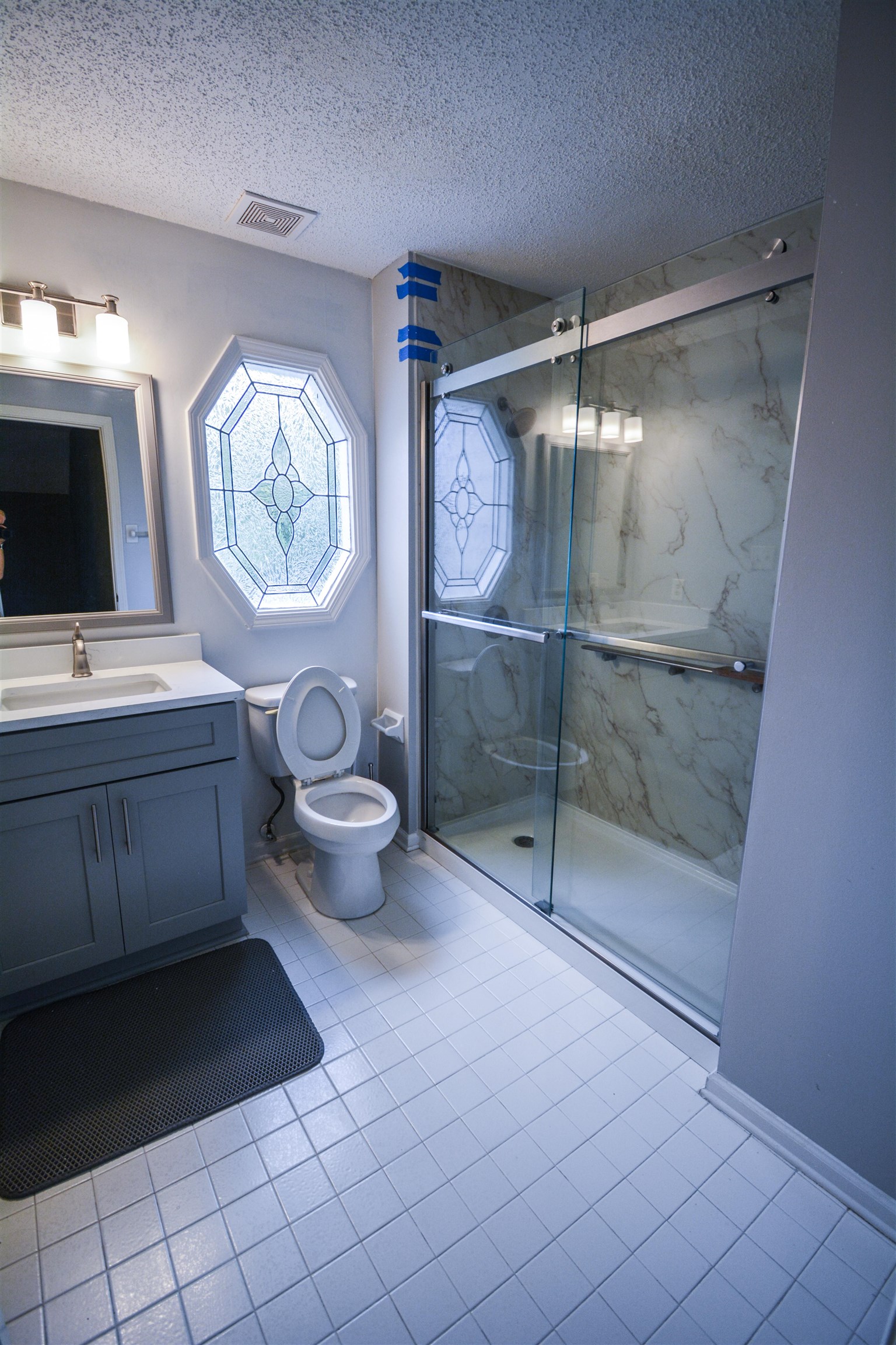 745 Roehampton Court Collierville, TN 38017 - Photo 35 of 40 Full bathroom featuring a textured ceiling, a marble finish shower, light tile patterned floors, and vanity