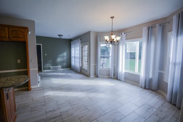 a view of a dining room with furniture and window