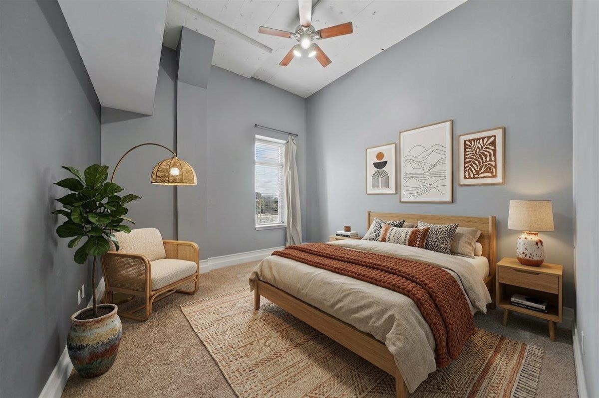 648 Riverside Drive, Unit 207 Memphis, TN 38103 - Photo 2 of 34 a bedroom with a bed and a chandelier