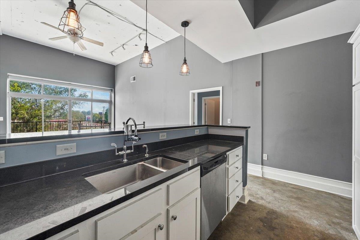 648 Riverside Drive, Unit 207 Memphis, TN 38103 - Photo 21 of 34 a kitchen with granite countertop a sink and a window