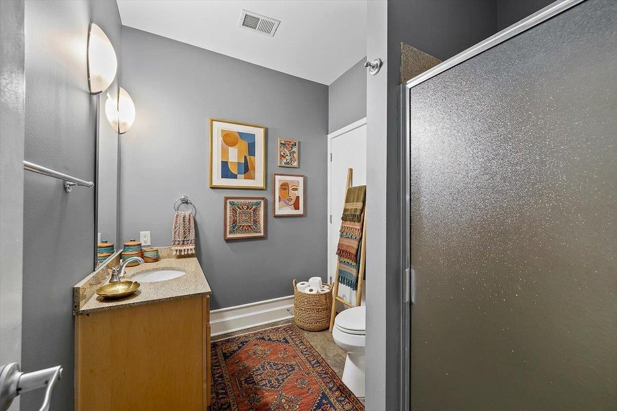 648 Riverside Drive, Unit 207 Memphis, TN 38103 - Photo 7 of 34 a bathroom with a sink mirror and toilet