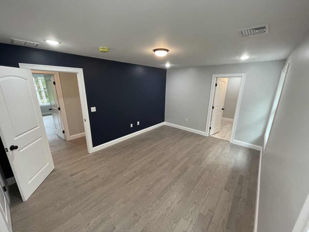 101 Folly Mill Road Salisbury, MA 01952 - Photo 24 of 32 an empty room with wooden floor and windows