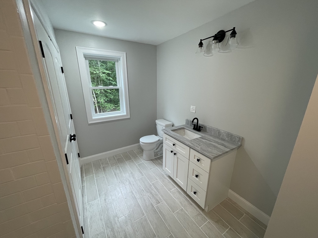101 Folly Mill Road Salisbury, MA 01952 - Photo 26 of 32 a view of bathroom with toilet window and hardwood floor