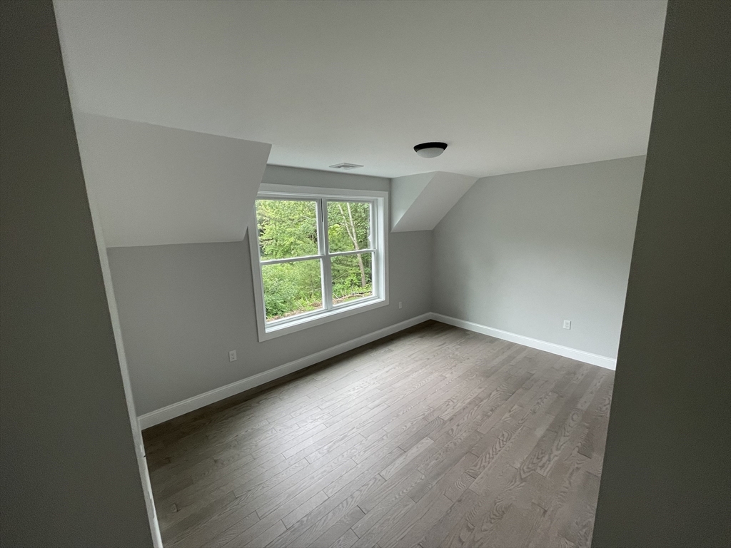 101 Folly Mill Road Salisbury, MA 01952 - Photo 27 of 32 an empty room with wooden floor and windows