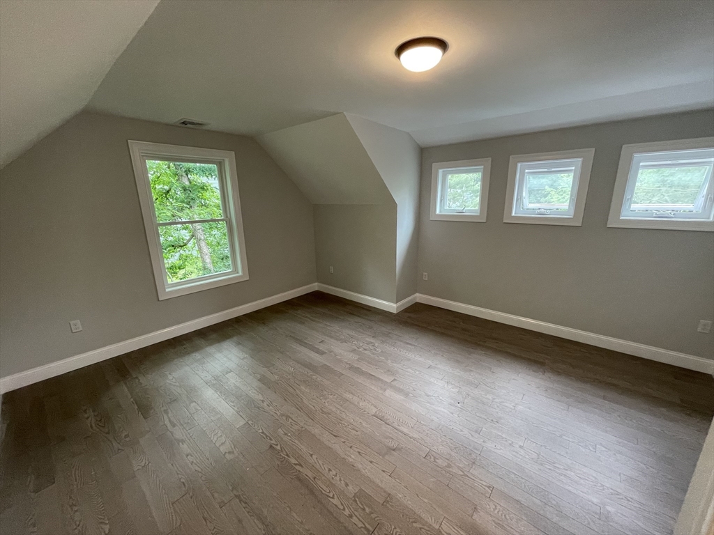101 Folly Mill Road Salisbury, MA 01952 - Photo 29 of 32 an empty room with wooden floor and windows