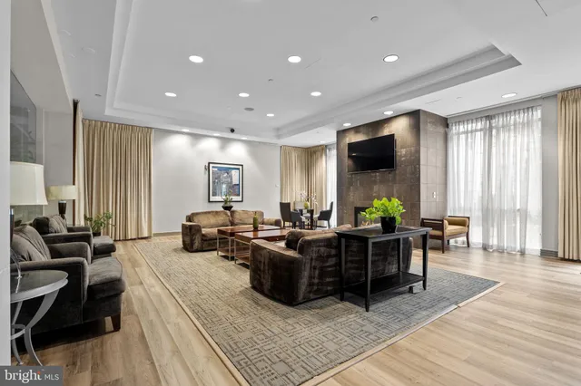 a living room with fireplace furniture and a flat screen tv
