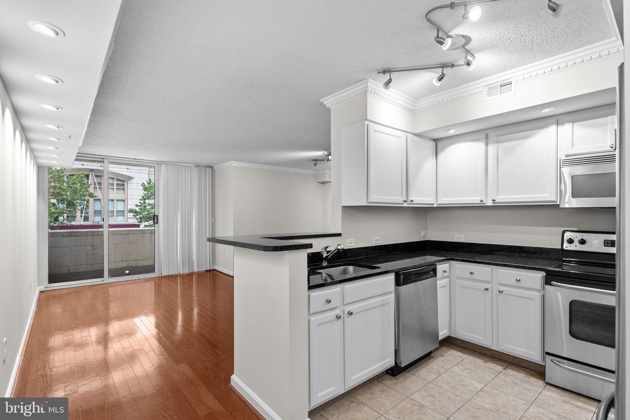 880 North Pollard Street, Unit 224 Arlington, VA 22203 - Photo 5 of 50 a kitchen with stainless steel appliances granite countertop a stove a sink and white cabinets