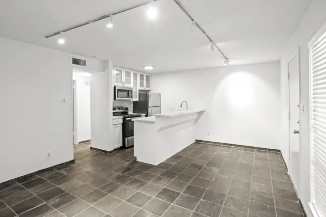 a kitchen with stainless steel appliances a microwave and sink