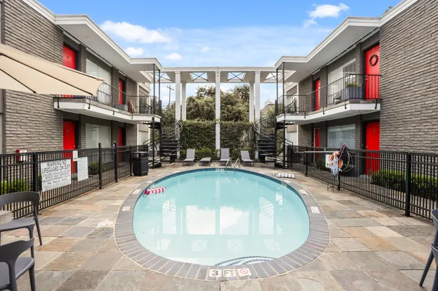 a swimming pool with outdoor seating and yard