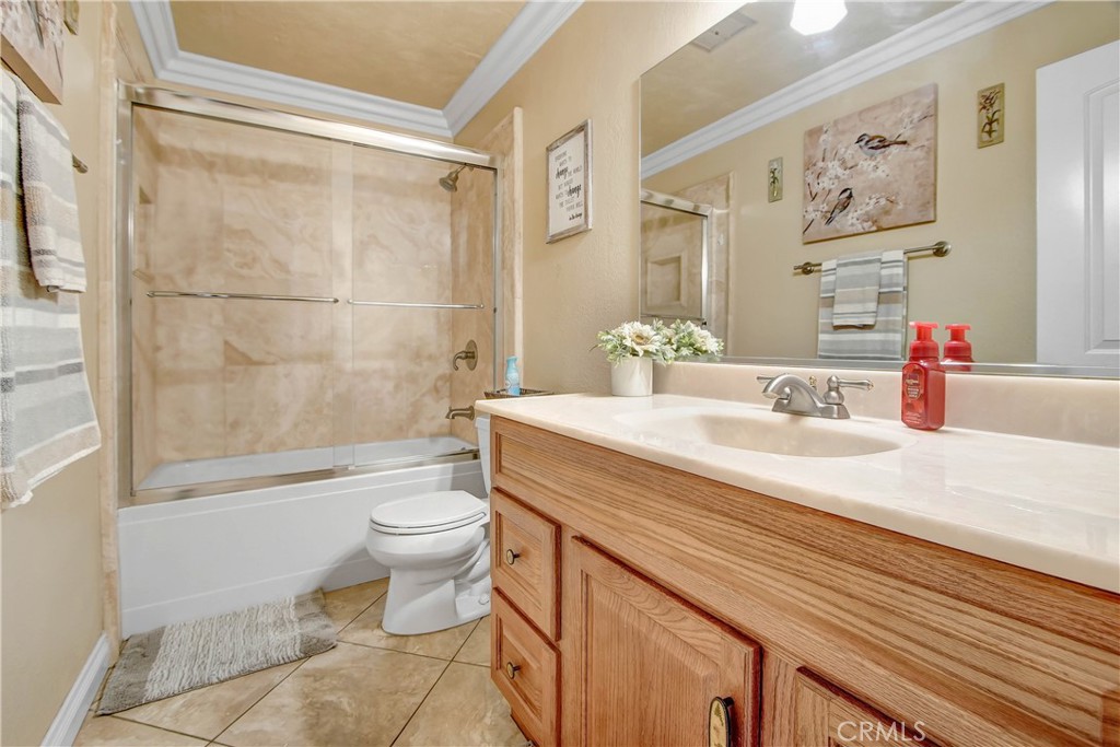 8555 Pigeon Pass Road Moreno Valley, CA 92557 - Photo 14 of 63 a bathroom with a sink a toilet and shower