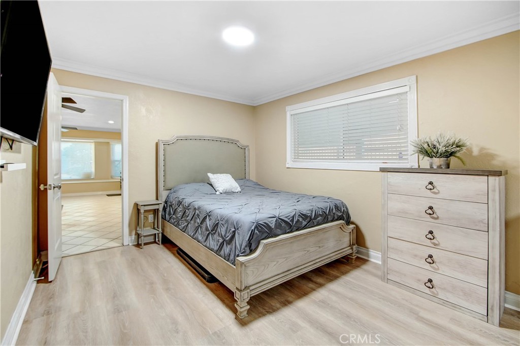 8555 Pigeon Pass Road Moreno Valley, CA 92557 - Photo 15 of 63 a bedroom with a large bed and a dresser