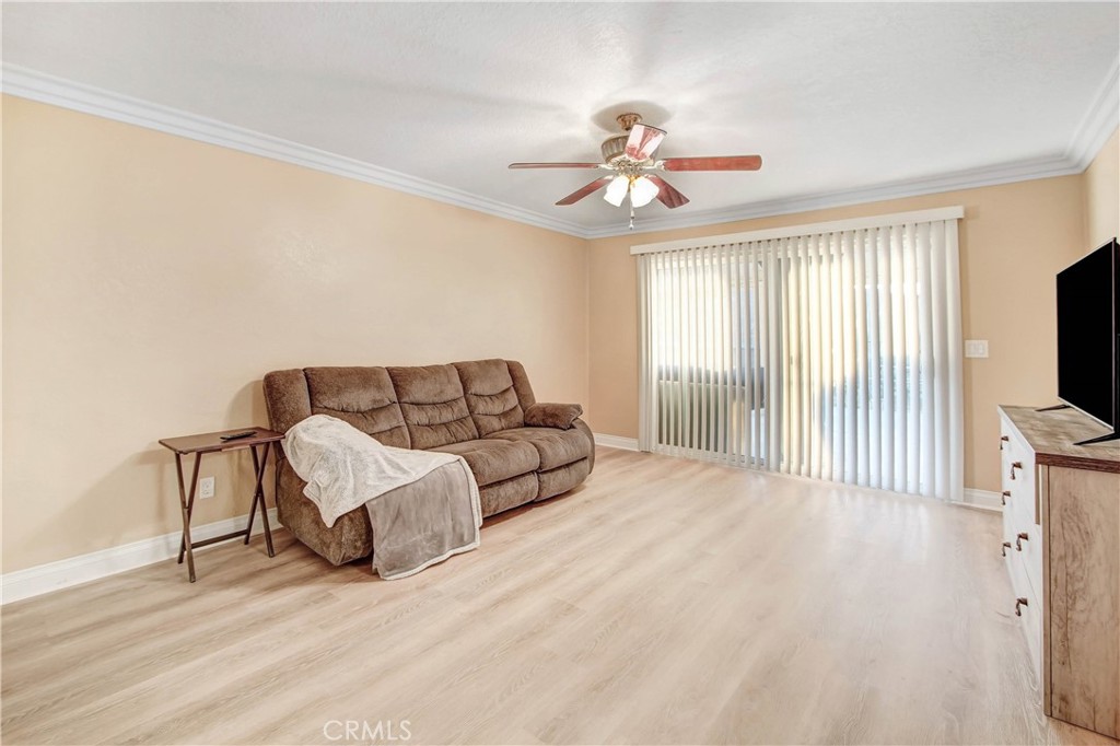 8555 Pigeon Pass Road Moreno Valley, CA 92557 - Photo 16 of 63 a living room with furniture and a flat screen tv