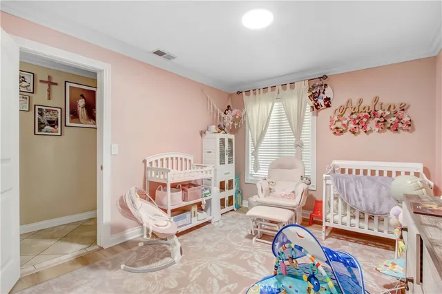 a bedroom with bed and a chandelier