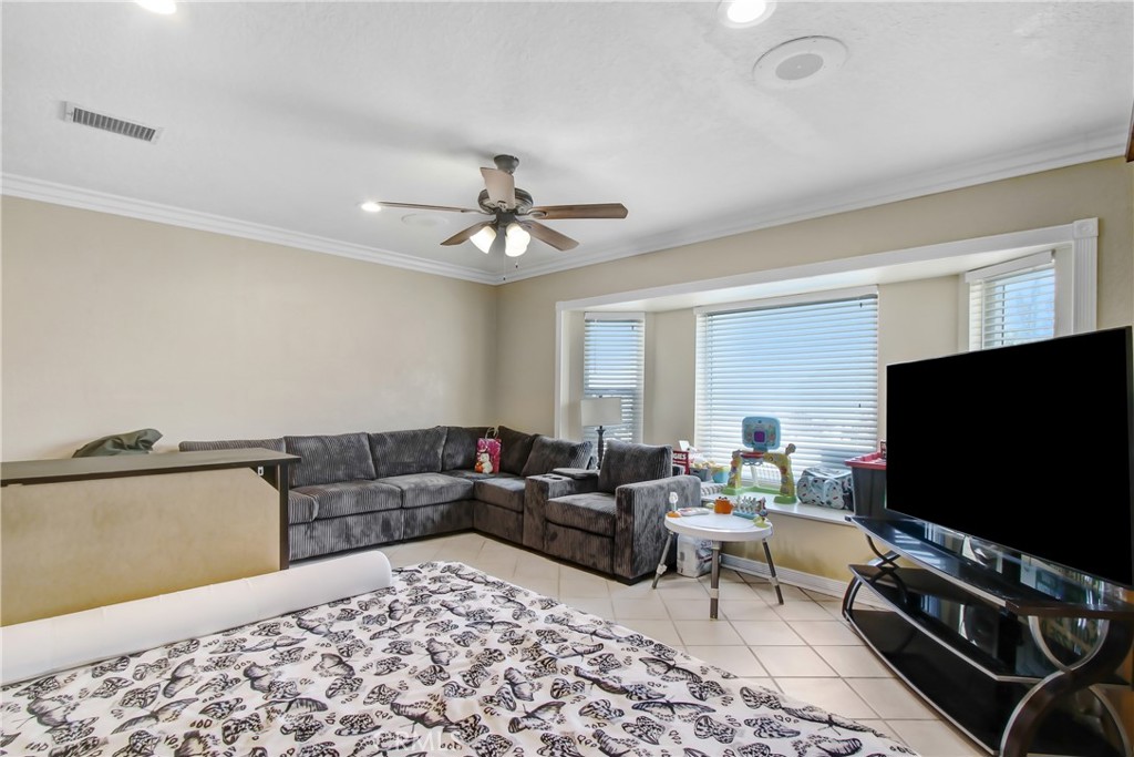 8555 Pigeon Pass Road Moreno Valley, CA 92557 - Photo 21 of 63 a living room with furniture and a flat screen tv