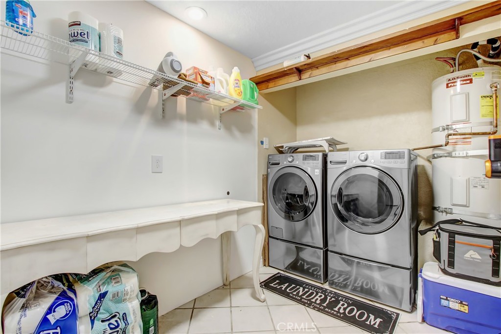 8555 Pigeon Pass Road Moreno Valley, CA 92557 - Photo 22 of 63 a utility room with dryer and washer