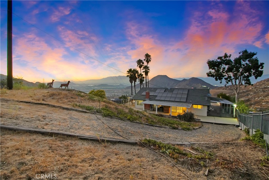 8555 Pigeon Pass Road Moreno Valley, CA 92557 - Photo 5 of 63 a view of a dry yard with wooden fence