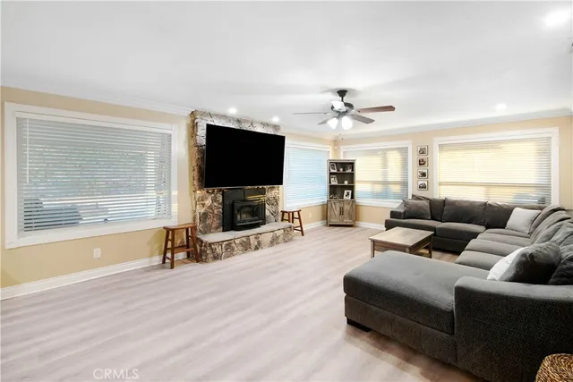 a room with stainless steel appliances kitchen island granite countertop a refrigerator and a sink