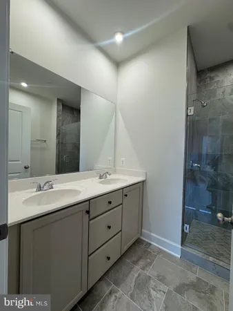a bathroom with a double vanity sink and a mirror
