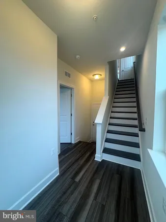 a view of entryway and hall with wooden floor