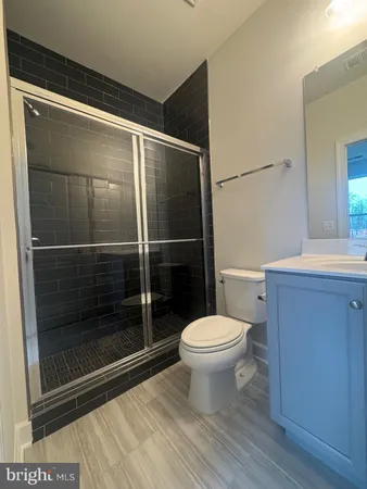 a bathroom with a toilet and a shower
