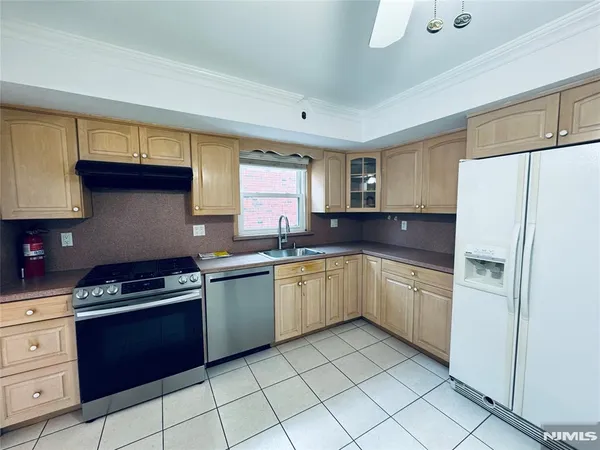 a kitchen with stainless steel appliances a stove a sink and cabinets