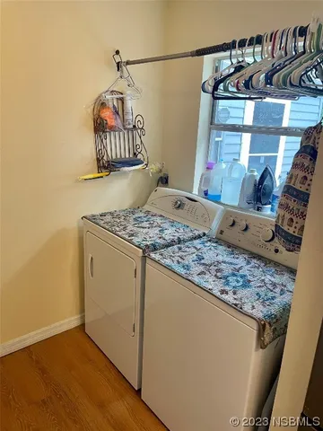 a dining room with furniture window and wooden floor