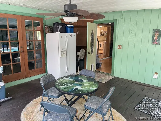 a dining room with furniture and wooden floor