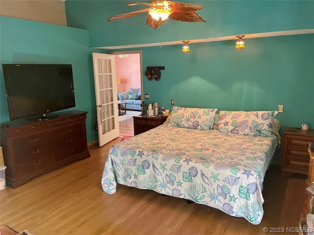 a bed room with a bed and a chandelier