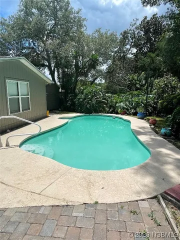 a view of a swimming pool with a yard
