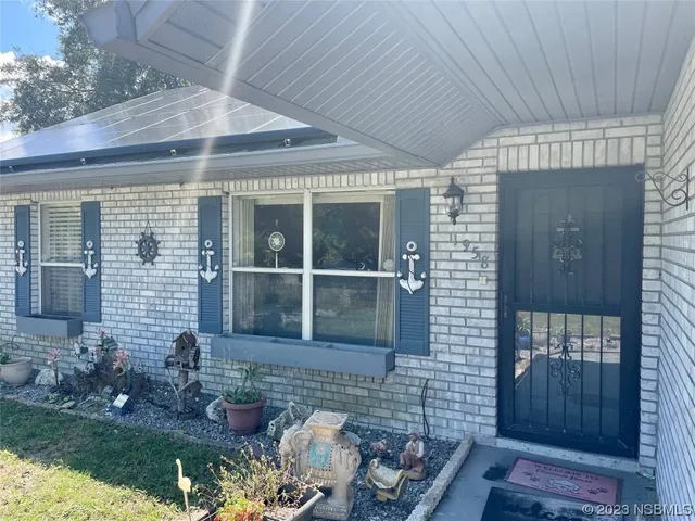 a view of a house with backyard space and sitting area