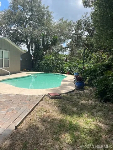 a view of a small house and a yard