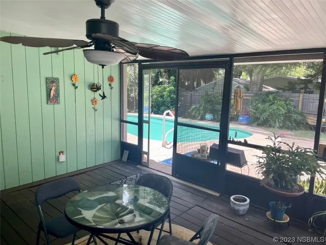 a view of a livingroom with furniture and floor to ceiling window