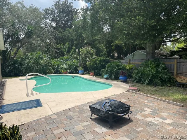 a view of a backyard with swimming pool