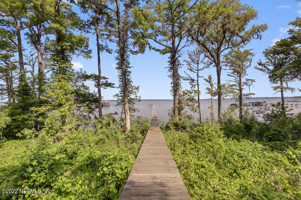 a view of a pathway with a wrought fence