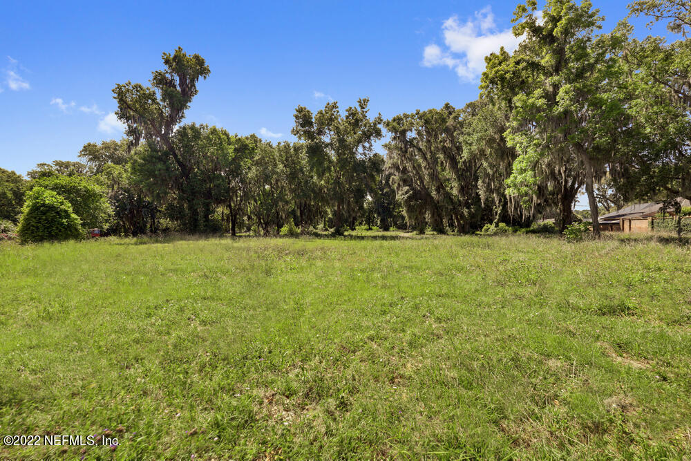 12274 Mandarin Road Jacksonville, FL 32223 - Photo 5 of 12 a view of a green field with trees in the background