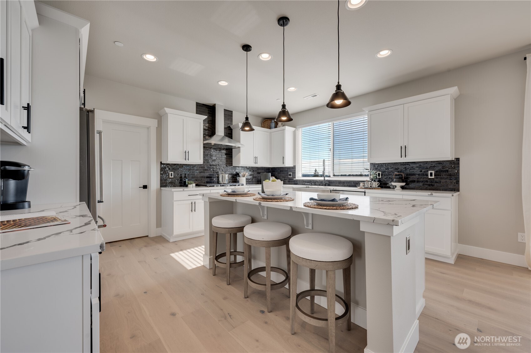 20411 125th Avenue Northeast, Unit SM 20 Bothell, WA 98011 - Photo 12 of 34 a kitchen with a sink a stove a refrigerator and white cabinets with wooden floor
