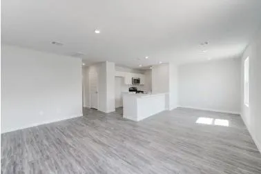 a view of a kitchen with wooden floor and window