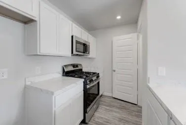 a kitchen with a sink and a stove top oven