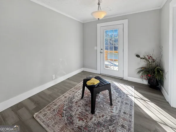 a view of an entryway with wooden floor