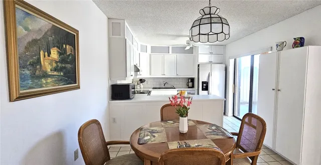 a living room with furniture and a painting on the wall